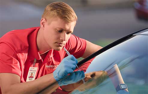 Auto Glass Repair & Replacement Services Glass Doctor specialist repairing a windshield crack