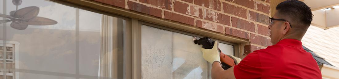 Glass Doctor specialist repairing a home window seal