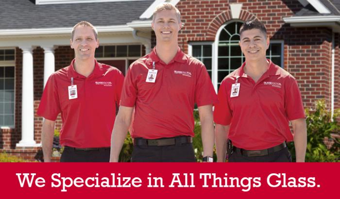 Glass Doctor specialists in front of a house with &quot;We Specialize in All Things Glass&quot; written below it